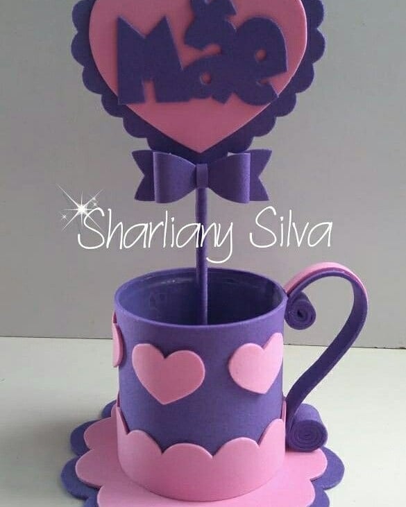 Centro de mesa em EVA em formato de xícara decorada com corações e plaquinha com a palavra “Mãe”, ideal para o Dia das Mães.