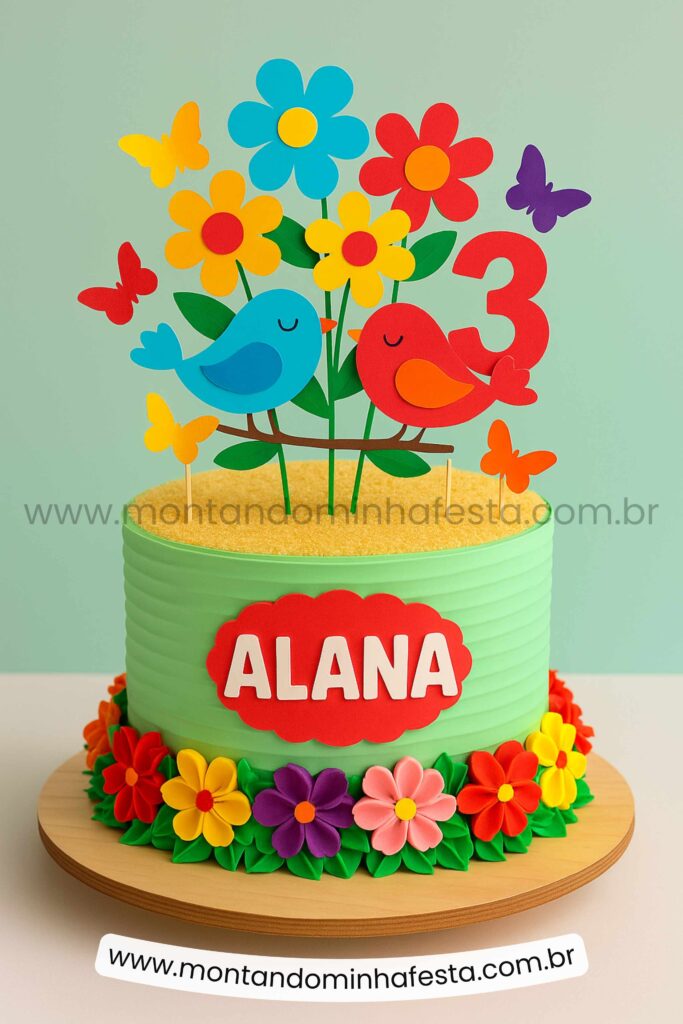 Bolo jardim encantado com passarinhos coloridos, flores em papel e nome personalizado – modelo criativo para festa infantil 3 anos.