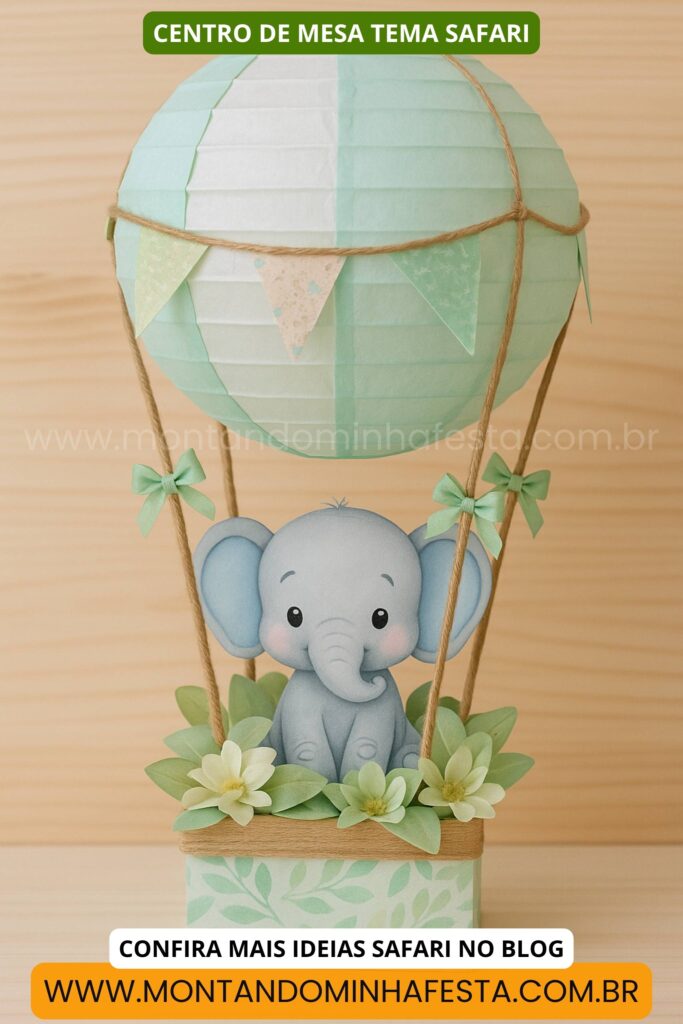 Centro de mesa tema safari com elefante em papel dentro de um balão decorativo verde claro com flores e bandeirinhas.